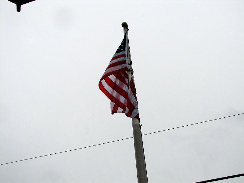 IMG_5432.jpg - In the dreary gray weather the American flag was raised to full staff then back to half staff in honor of those lost in the terror attack at Fort Hood, Texas, the previous week.