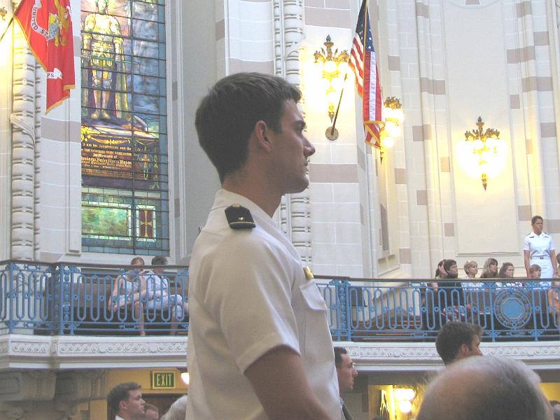 IMG_3118.JPG - A graduating Midshipman stands during the service as all Middies were thanked for their service to the United States of America and blessed to be protected especially when in harm’s way in performing their duties.
