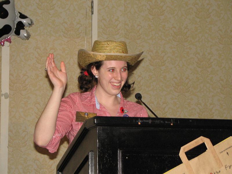 IMG_2431.JPG - Top Farmer and Key Club Governor Christina Horton opens the 60th Annual District Convention with a hoot and a holler by jumping off a John Deer tractor and dancing her way to the podium with a “Mooove To Service