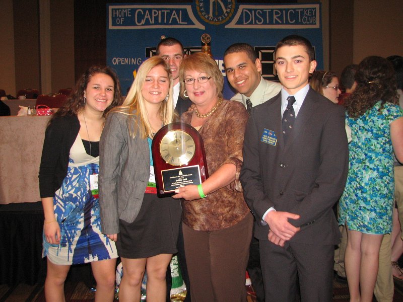 IMG_0849.JPG - The very prestigious Scott Hunter Key Leadership Award for Outstanding Service to Capital District Key Club goes to … Debbie Todd, Zone Administrator.  Among those taking part in the presentation of the engraved plaque with golden clock is Governor Rachael and District Treasurer Alex Burkard.  WOW !