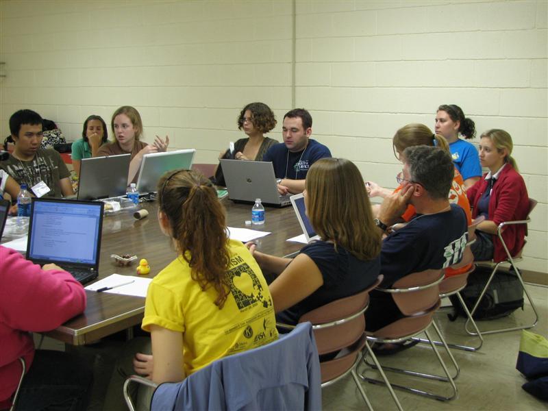 IMG_0444.JPG - Now look at this closely.  The CKI Board takes tele-computing up a notch.  While seated at a large conference table, board members look at each other and ‘talk’ by interactive PCs at the table.  Yes, they do some actual verbal talking while keyboarding too.  Quite efficient, really, and it’s all recorded.  A moderator “the Gov” keeps them on topic.  Try it!