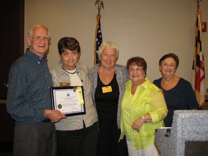 IMG_5388.JPG - All the club members support these club awards.  The Wheaton-Silver Spring Club’s members stand with Walt.  From the left, President Walt Petzold the “Unsung Hero” with President Helen Williams, Vice President Murmi Morrill, Lt. Governor Division 17 Joyce Sharon and Club Secretary Rita Schief.   Team players all.