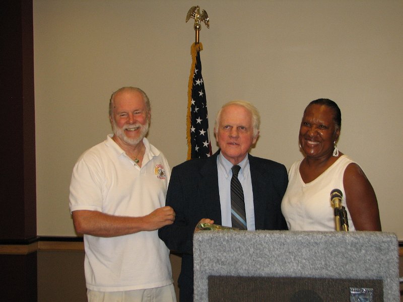 IMG_5391.JPG - Past Governor of the Capital District John Tyner presenting Tom McIsaac (center) the “Unsung Hero” award with the Rockville Kiwanis Club President Elect Georgia Eaves looks on with a big smile of congratulations.
