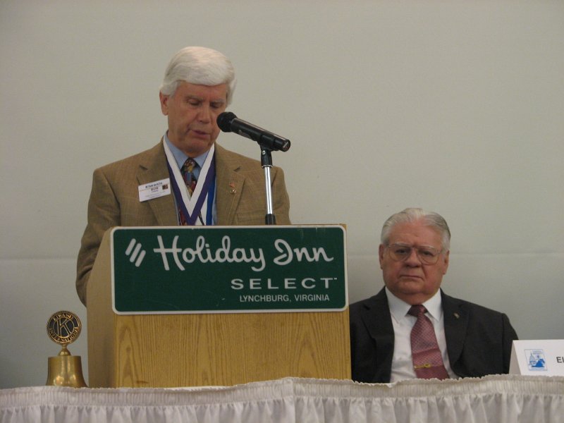 IMG_1986.JPG - Past Gov Bob Cressy reads the resolutions during Sunday's House of Delegates. Sec. Ellis Stroup looks on.