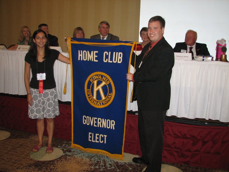IMG_2038.JPG - Exchange of Governor-Elect Banner from Ashland Club to the Tyson’s Corner Club;  Mitra Irdmusa – President elect Tyson’s Corner Club and Derek Dupuis – Ashland Club.