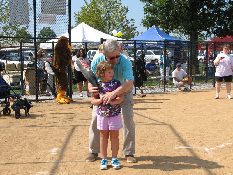 IMG_8886.JPG - Everyone gets to bat, often many times … its offense you see. This young girl (names of the kids and parents are not used in publications, but have signed release forms) gets some batting coaching by Jim Aylor, Past President of the Bethesda Club.  She’s ready to go.  Strike one, strike two (see how Jim helps?) … it’s a HIT!