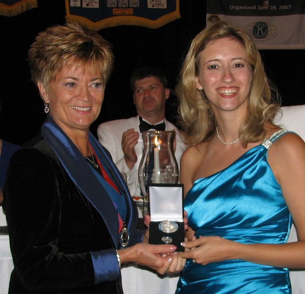 146.JPG - Our new First Lady Jen Wolff receives the Walter Zeller Charter Membership award from KI Trustee Jane Erickson. Each Zeller contribution of $1,250 helps save the lives of 690 infants and mothers simply by supplying the series of tetanus shots to control the disease. Thank you, Jen. Thanks to all the Zeller Charter Members for contributing to the Eliminate Project.