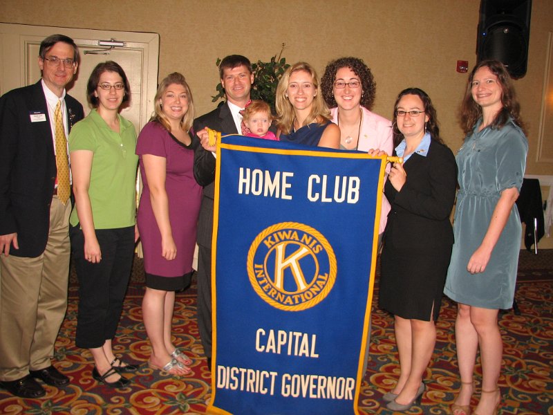 175.JPG - Gathering behind the Governor's home club banner after the DCON installation ceremony are (L to R) David Lurie, Maureen Frank, Corey Goggin, Gov. Designate Jeffrey Wolff, Charlotte Wolff, Jennifer Wolff, Nicole McDermott, Kristina Dlugozima, Stacy Bruss.