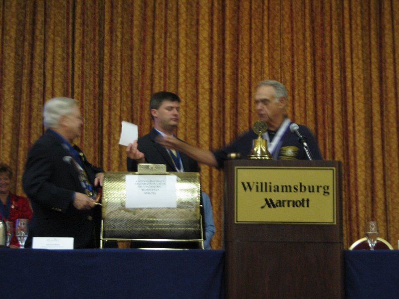 IMG_5190.JPG - Now, note that only Governor Elect Jeff Wolff is the one drawing the winning tickets from the hopper. There is a reason I’m showing you this. You’ll see. Left to right, CDKF President Elect H. L. Marks cranks the crank; Gov. Elect Jeff is drawing the tickets. PP Joe gets the tickets and reads the winner’s name. Suspense.