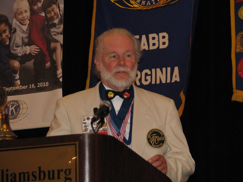 IMG_5244.JPG - Past Governor John Tyner is the Master of Ceremonies for a streamed video to Ellis broadcast from the podium at the convention.